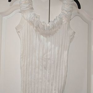 Bellini sleeveless ruffled neckline ribbed top